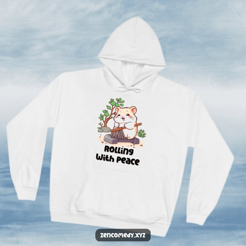 Funny hoodie featuring a bouncing hamster peacefully rolling a zen garden rake, perfect for cozy and meditative moments.